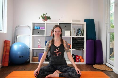 Woman seated on a yoga mat